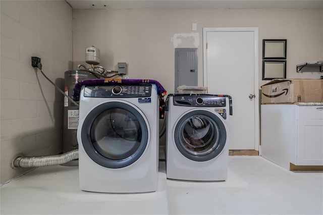 washroom featuring electric water heater and washing machine and dryer