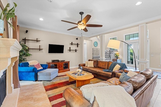 living room with crown molding, light tile patterned floors, ceiling fan, and a fireplace