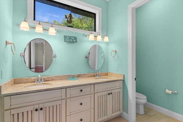 bathroom featuring vanity and toilet