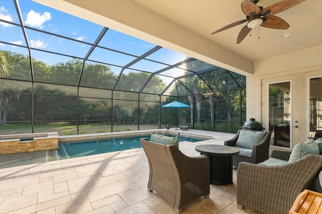 view of swimming pool with ceiling fan, a lanai, and a patio area