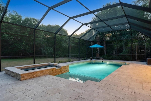 view of pool featuring an in ground hot tub, a lanai, and a patio area