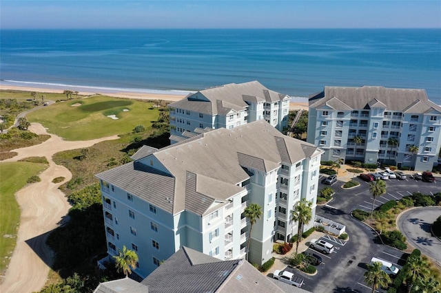 aerial view with a water view and a view of the beach