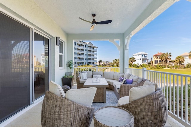 balcony with an outdoor living space and ceiling fan