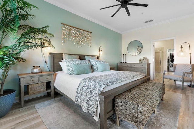 bedroom with ornamental molding and hardwood / wood-style floors