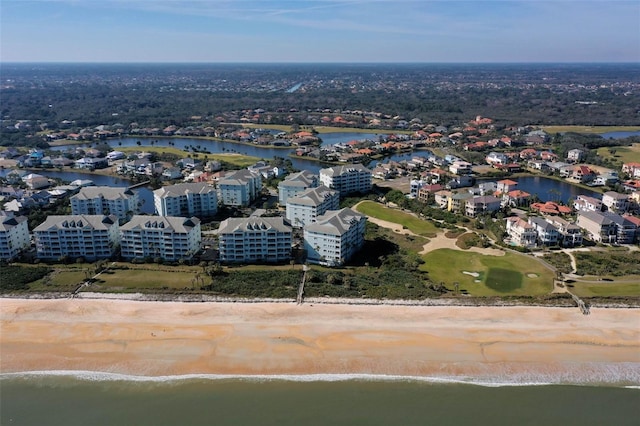 bird's eye view with a water view and a beach view