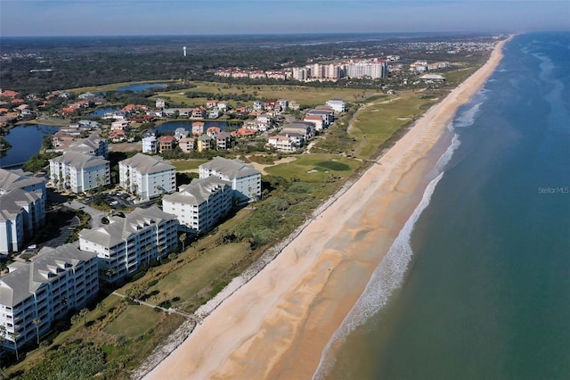 birds eye view of property featuring a view of the beach and a water view