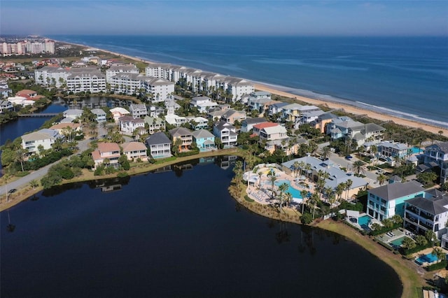 bird's eye view featuring a water view and a view of the beach