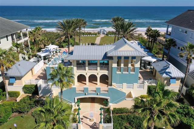 birds eye view of property with a water view and a view of the beach