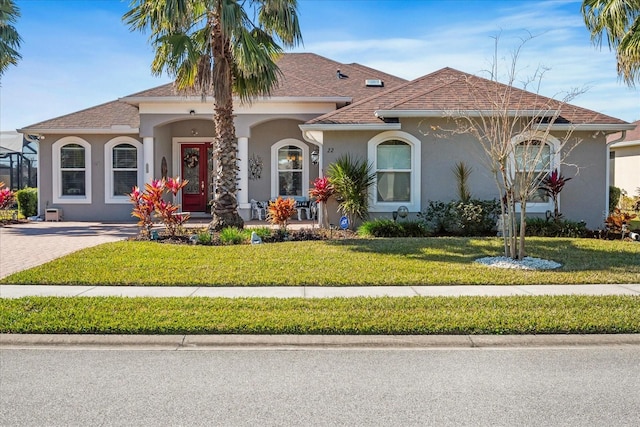 mediterranean / spanish house with a front yard