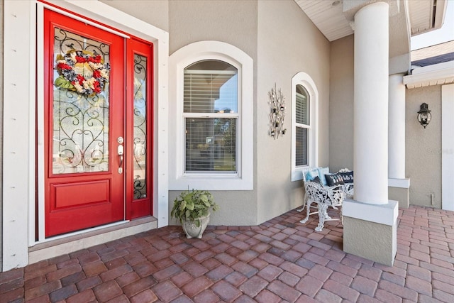 view of exterior entry with covered porch