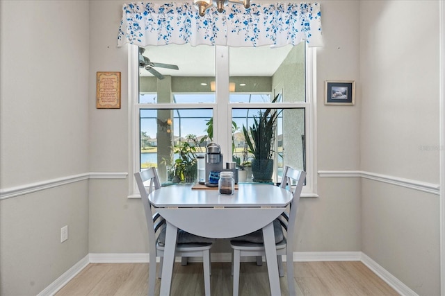 dining space with ceiling fan and light hardwood / wood-style flooring