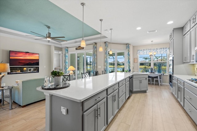 kitchen featuring pendant lighting, a kitchen island, and gray cabinetry