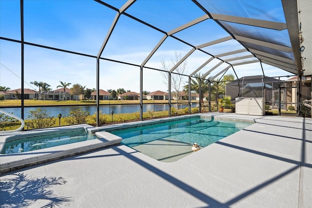 view of pool featuring a patio, a water view, and glass enclosure