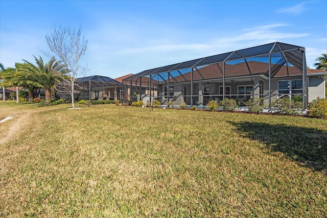 exterior space with glass enclosure and a lawn