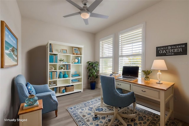 office with light hardwood / wood-style floors and ceiling fan