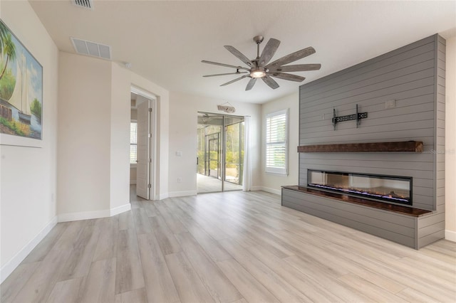 unfurnished living room with ceiling fan and light hardwood / wood-style floors