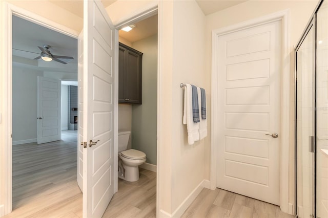 bathroom featuring ceiling fan, wood-type flooring, and toilet