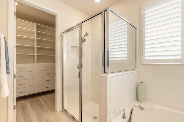 bathroom featuring separate shower and tub and hardwood / wood-style floors