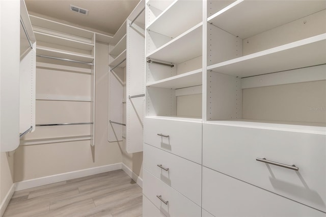 walk in closet featuring light hardwood / wood-style flooring