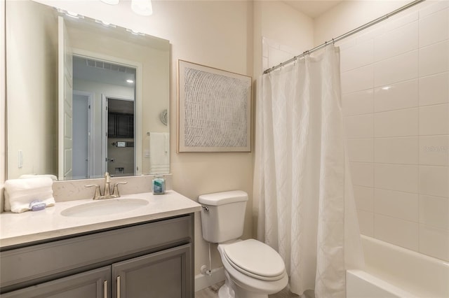 full bathroom featuring vanity, shower / bath combo, and toilet