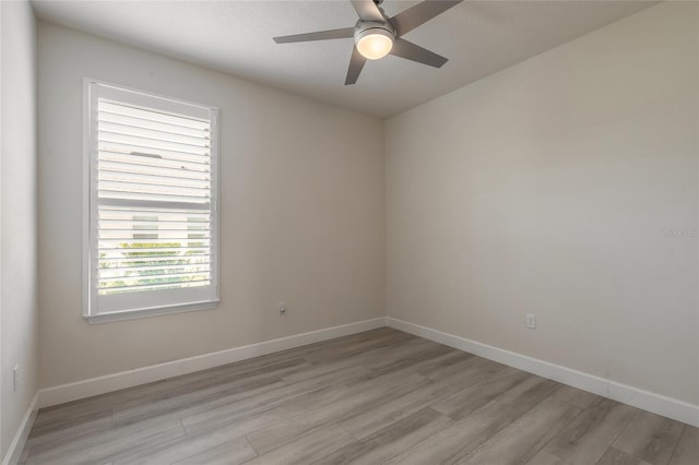 unfurnished room with ceiling fan and light wood-type flooring