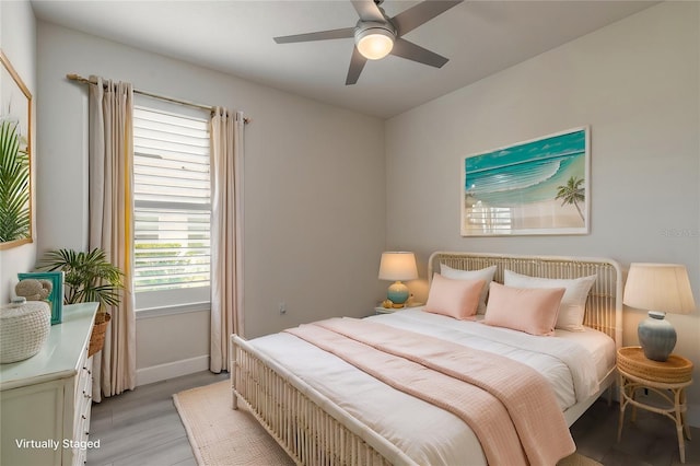 bedroom with ceiling fan and light hardwood / wood-style flooring