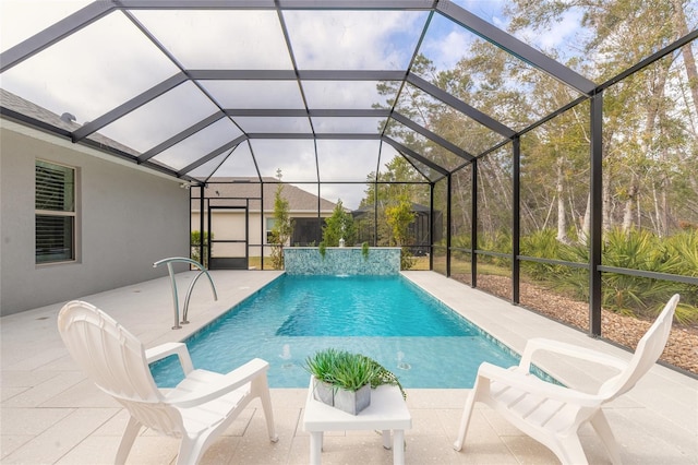 view of swimming pool with pool water feature, a patio area, and glass enclosure