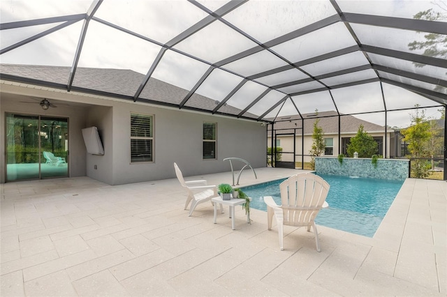 view of swimming pool featuring pool water feature, ceiling fan, a lanai, and a patio area