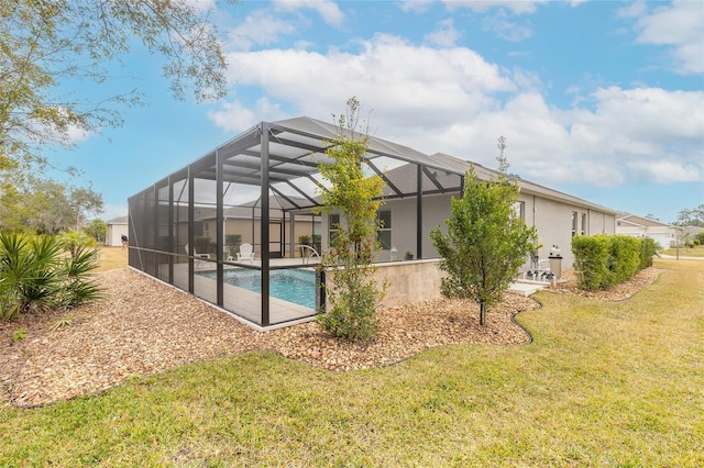 rear view of property with glass enclosure and a lawn