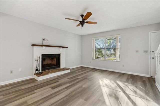 unfurnished living room with hardwood / wood-style flooring and ceiling fan