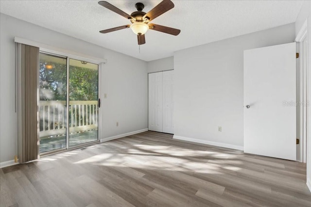 spare room with ceiling fan, hardwood / wood-style flooring, and a textured ceiling