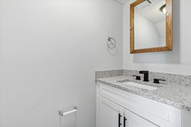 bathroom with vanity and a textured ceiling