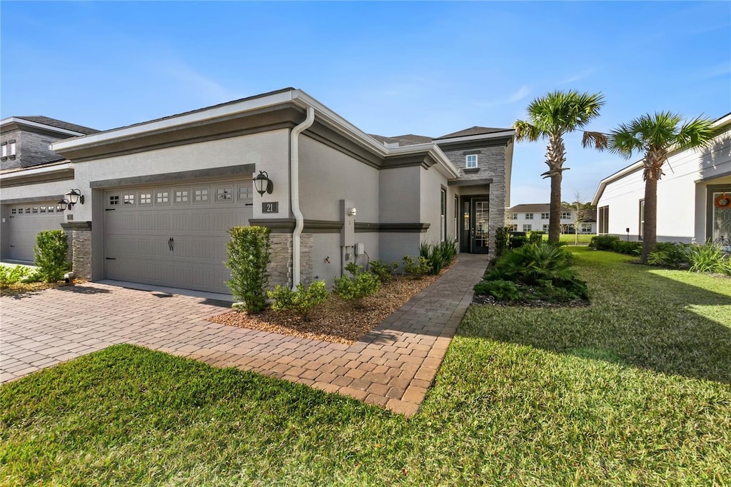 view of front facade with a garage and a front yard