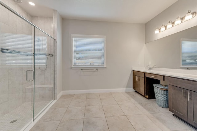 bathroom featuring tile patterned floors, vanity, and a shower with shower door