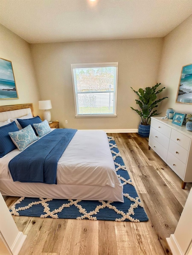 bedroom with light hardwood / wood-style flooring