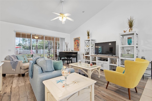 living room with high vaulted ceiling, ceiling fan, and light hardwood / wood-style flooring