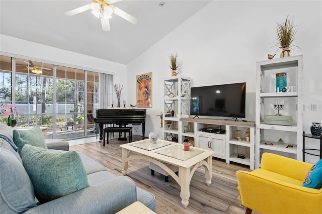 living room featuring ceiling fan, high vaulted ceiling, and hardwood / wood-style floors