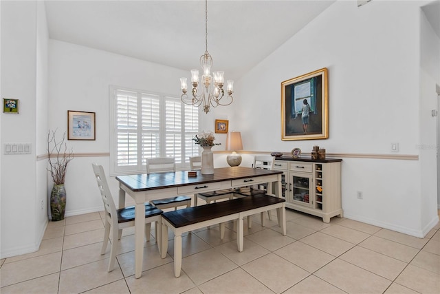 dining area featuring light tile patterned floors, vaulted ceiling, and a chandelier