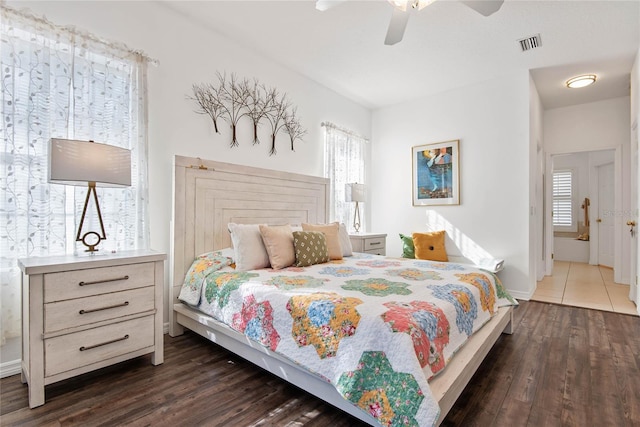 bedroom with dark hardwood / wood-style floors and ceiling fan