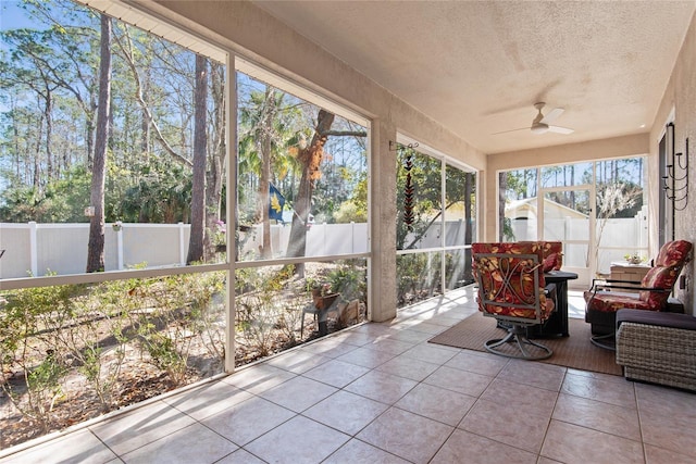 sunroom / solarium featuring ceiling fan