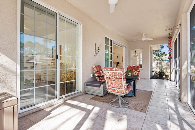 sunroom / solarium featuring ceiling fan