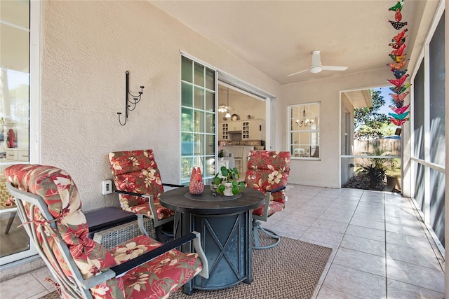 sunroom / solarium featuring ceiling fan