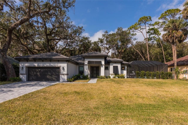 prairie-style home with a garage, a lanai, and a front yard