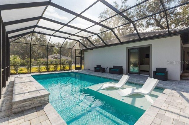 outdoor pool with a patio and a lanai