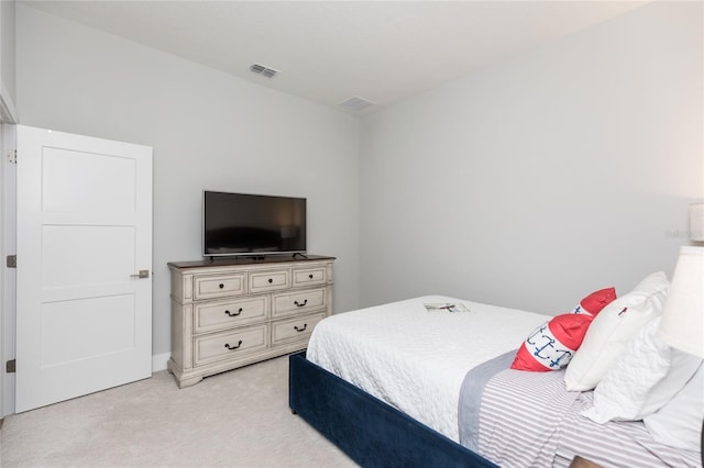 bedroom with visible vents and light colored carpet