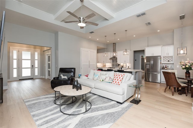 living room with recessed lighting, light wood finished floors, visible vents, a ceiling fan, and beamed ceiling