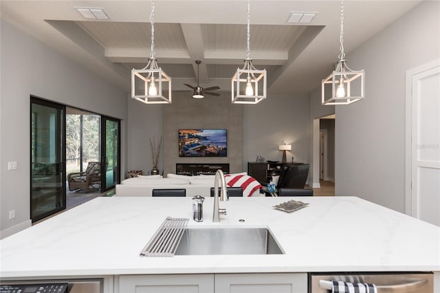 kitchen featuring beamed ceiling, open floor plan, visible vents, and a sink