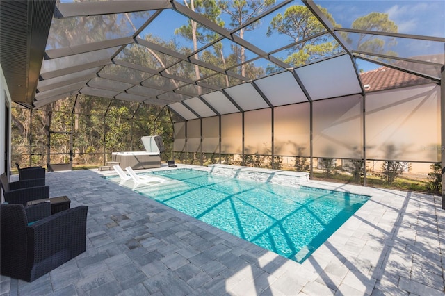 pool with a patio area and glass enclosure