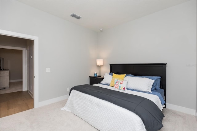 bedroom featuring carpet, visible vents, and baseboards