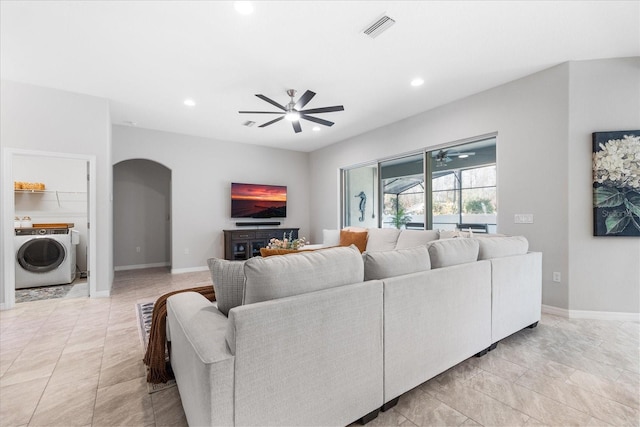 living room with washer / clothes dryer and ceiling fan